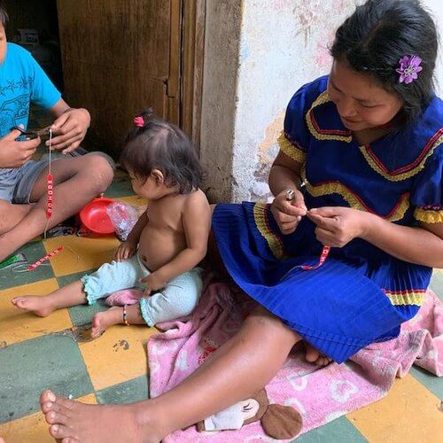 Embera Indigenous family making jewelry in Medellín