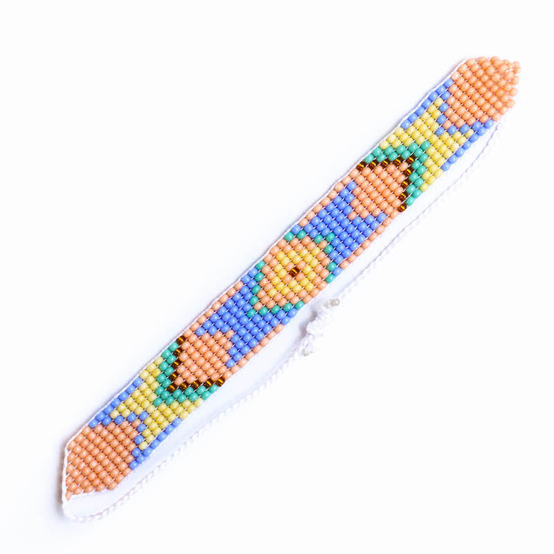 A peach, blue, yellow, and green indigenous inspired beaded bracelet with a slip knot closure.