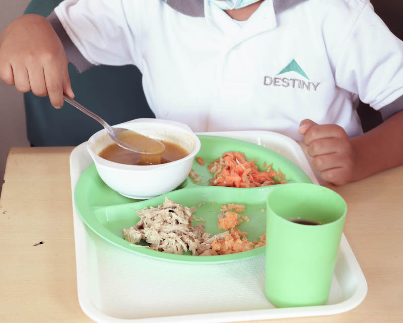 Child eating at Destiny Cafeteria