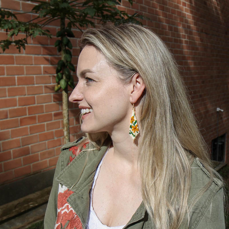 Model wearing Jardin Botanico Embera Bead Project Earrings