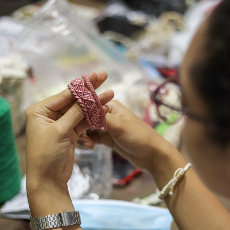 Knot Bound artisan making macrame bracelets